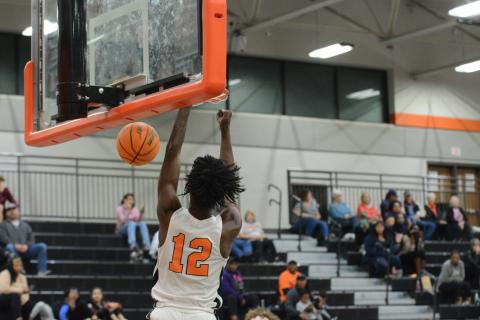 Senior forward Terrance Mitchell slams it home in the Dogs home opener on Nov. 10 against Madison County.