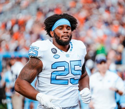 North Carolina Tar Heel Kaimon Rucker trots onto the field before a 36-34 win over Wake Forest which clinched the Coastal Division and an appearance in the ACC Championship vs. Clemson.  
