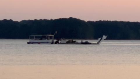 Authorities working with a professional dive team retrieve Carrell's body and plane in Lake Hartwell.