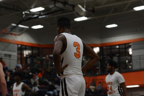 Tahj Johnson stands in along the lane during a free throw.