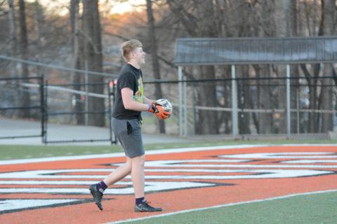 Junior goalkeeper Ayden Thomason gets ready to send the ball down field as the soccer Dogs prepare for their season opener on the road versus Cedar Shoals on Friday, Jan. 27.