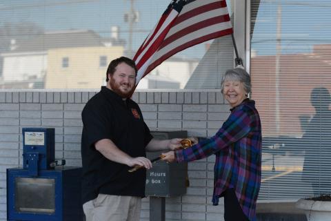 Joyce Kilpatrick (right) presents Hartwell resident Sam Simpson (left) with a Navy officer ceremonial sword that originally belonged to his late grandfather. Kilpatrick bought the sword at an auction before doing some investigating and returning it to its family.   