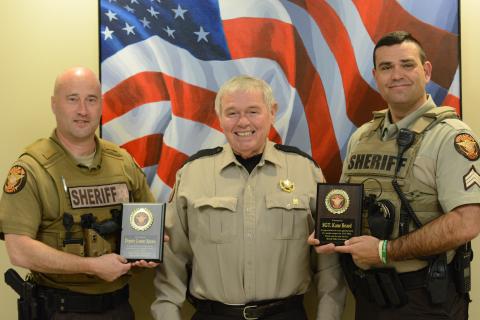 Hart County deputy Lamar Spears (left) and Sgt. Kane Beard (right) are awarded plaques from sheriff Mike Cleveland for their roles in the arrest of Andrew Nicholas Berry, who is accused of killing his girlfriend on Dec. 31.