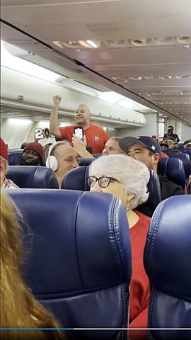 Pictured is a screencap of a video taken of Hartwell resident Brooks Mewborn, who went viral for the scene above, where he started a UGA chant on a plane hours after the school’s second consecutive national championship.   