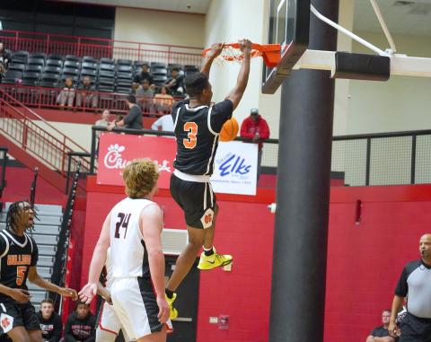 Senior forward Tahj Johnson slams it home in the 67-62 road win over Stephens County.