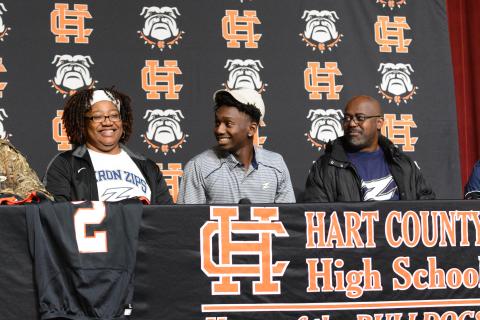 Pictured left to right: Davis’ mother, Dannette, senior wide receiver Paul Davis, and father William decked out in Akron Zips gear as Davis commits to Akron on National Signing Day.