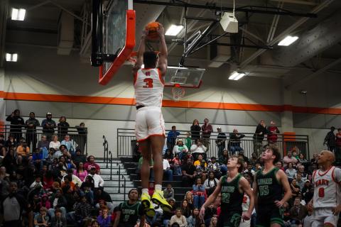 Senior Tahj Johnson rises above the rim to slam it home as he led the Dogs with 18 points in Hart County’s  win over the Franklin County Lions, 73-60 at home on senior night. (Photo by Lexie Wheless)