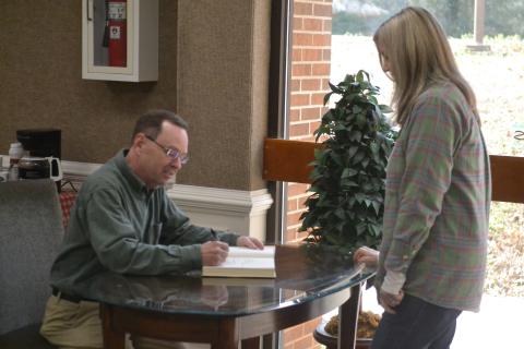 New York Times bestselling author John Cribb (left) signs a copy of his latest book, “The Rail Splitter” for Gwen Walters (right), of Hartwell, during a book signing and talk at the Hart County Library Jan. 26. 