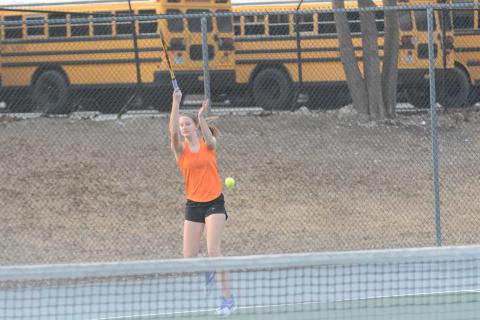 Ava Carnes returning a serve.