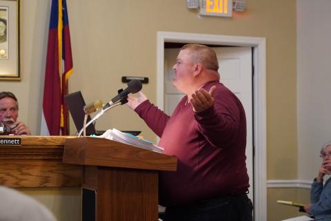 Charlie Pierce explains to the board that he should be allowed to build a duplex on his property despite the current moratorium on multi-family residential housing. 
