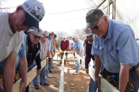 Members of Hart County’s Golden K club lower the framing into place for a new ramp at a local resident’s house on Tuesday. The ramp marked the group’s 800th access ramp built within the community.