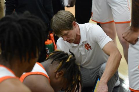 Dogs head coach Matt Gibbs draws up a play during a home game from earlier in the season.