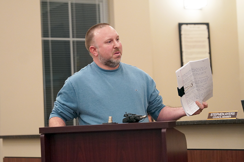 Hartwell resident and Franklin Springs Police Chief Kevin Thompson holds up a “15-page memo,” which discusses complaints about Parkdale Drive. Thompson claimed the memo contained unnecessary personal information about him, including his place of employment and title.