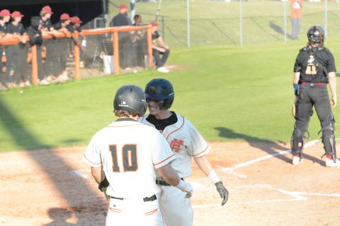 Junior Zack Dombrowsky (10) and senior Jordan Leach celebrated as the Diamond Dogs swept Washington-Wilkes at home on April 13, by scores of 7-6 and 10-6.