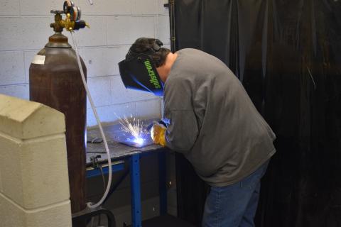 Sue Couch, a participant in the second installment of the adult welding class, works on her final project at the end of the four-week course. 