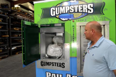 Gumpsters creator Kim Herron displays how his “pay as you throw” receptacle is used. The Hart County Board of Commissioners is the first municipality to incorporate the solid waste disposal option. 
