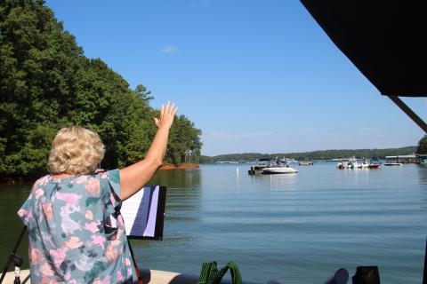 Worship leader Sherry Lewis is shown speaking at one of the services held during the first season of Water’s Edge Ministry at Lake Hartwell. 