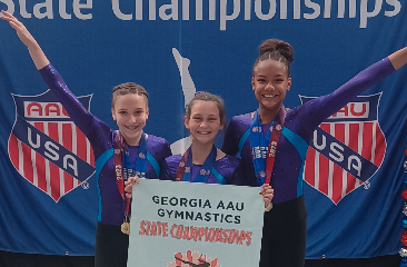 Pictured from left to right Madalyn Dault, Maci Dudley, Cheyenne Rucker who are the XCEL Diamond state champions.