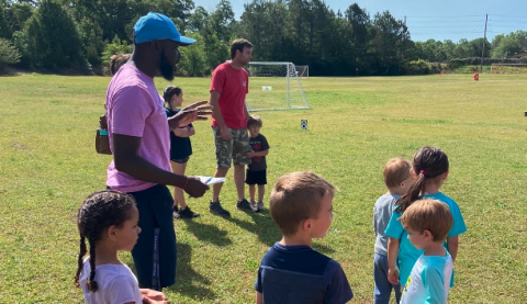 Bell Family YMCA sports director Kurve Augustine (pictured left with the hat) with kids during the second annual Healthy Kids Day on April 22.