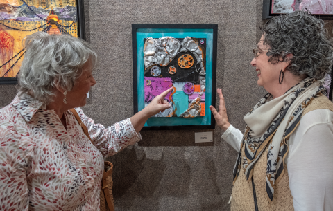 Above, (L-R) Lynn Smith and Diana Walter discuss Diana’s art during the Hartwell Art Center’s opening reception for ‘Awakenings’ May 5. Below, art patrons view the artwork in the show. 