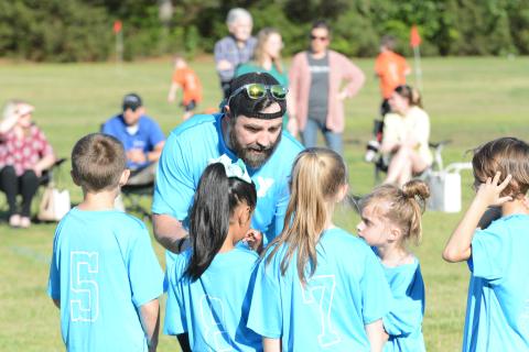 Tim Allgood coaches up his team before a game for the YMCA soccer league.