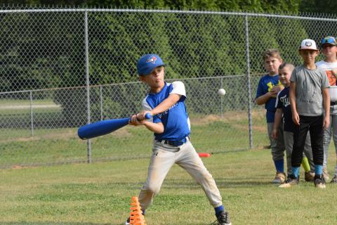Knox Payne (left) works on seeing the ball all the way through during HCHS baseball’s camp on June 5-8.