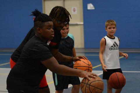 Pictured from left to right is Jeremy Dunkins, Nyje Willis, Jackson Dallas, and Logan Hubbard as they walk through a dribbling drill during the YMCA basketball camp.