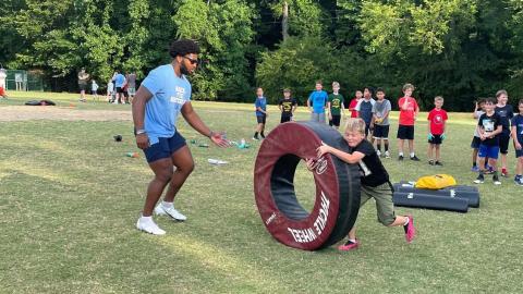 North Carolina Tar Heel football senior defender Kaimon Rucker serves at a youth football camp in Chatham County, NC in June of 2022. Photo by the University of North Carolina Athletics