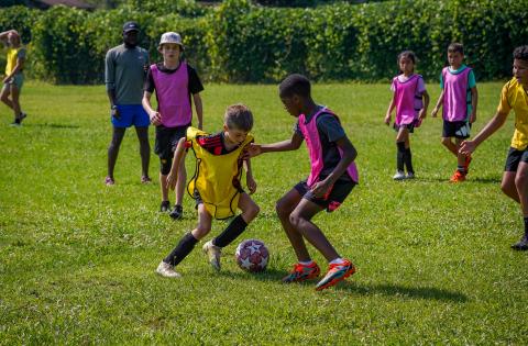 Kingston Durham (left in yellow jersey) tries to dribble around Camber Fenly (right) during the final week of soccer camps at the Bell Family YMCA on June 26-30.