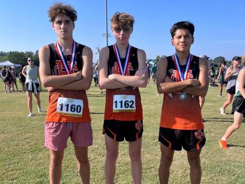 Pictured from left is Nate Harris, Braydon Lane, and Luis Genchi as they placed in the Top 20 to propel the boys team to a fifth place overall finish in the North Georgia Championships Aug.26 in Jefferson.