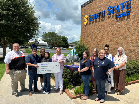 Pictured, from left to right, are HCHS Principal Kevin Gaines, South State Branch Manager Justin Price, HCMS Principal Jacqueline Brock, South State employee Samantha McClure, OneHartBeat Foundation Director Bobbie Busha, South State employees Kayla Poole, Lisa Pickett, Wendy Holcomb, Karen Leverett, and OneHartBeat Foundation Board Member Wyndee McKinnon.