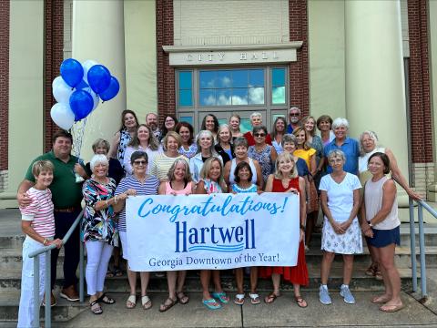 Pictured celebrating the City of Hartwell being named the Georgia Downtown of the Year are (first row, from left) Main Street volunteers Mary Lynn Johnson, Nancy Butler, Deb Kulcsar, Wendy Patterson, Carol Beazley, Diane Evans, Bo Bynum, Gretchen McClymont; (second row, from left) Main Street Coordinator Peggy Vickery, City Manager Jon Herschell and Main Street volunteersTammy Hutchinson, Nancy Hardigree, Helene Brown, Pat Harper, Sandra Baker; (third row, from left) Main Street volunteers