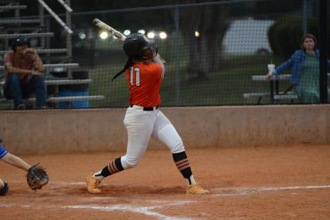 Senior infielder Jazz Shealer hits a hard hit ground ball down the third base line to bring home the tying run from first base in the 7-3 road lost to the Lady Warriors of Oconee County.
