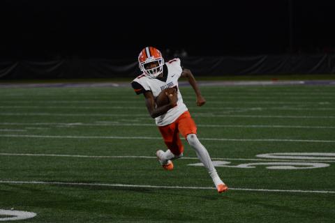 Freshman quarter back Kurston Curry keeps the football and attempts to pick up the first down in the road loss to the Indians of Lumpkin County, 30-10 in Dahlonega Sept. 15.