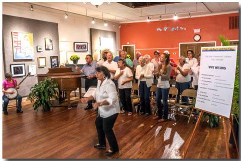 Maureen DeLoach engages the audience to sing during a performance of the Hart Area Community Chorus. 