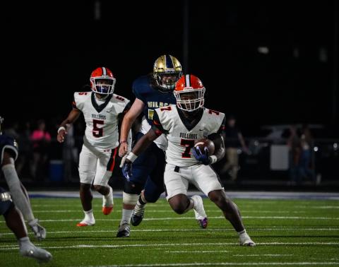 Senior quarterback Jashon Gaines (5) hands the ball off to senior running back Nori Moore who rushes in for the score in the Dogs 17-10 win over the Wildcats of Apalachee Sept. 1. (Photo by Lexie Wheless)