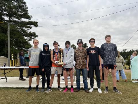 Pictured is the Hart County High School boys cross country team hoisting the first place trophy as they placed first in the purple division at Athens Christian Oct. 14. From left to right is Will Bell, Damian Childress, Nate Harris, Braydon Lane, Donavin Layman, Zach Simmons, and Ethan Stovall. 