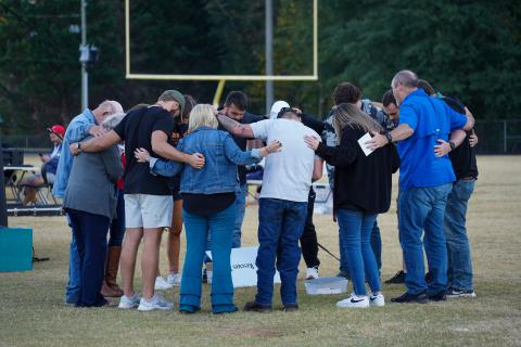 Pictured is the Fields of Faith leadership team praying before the event. 