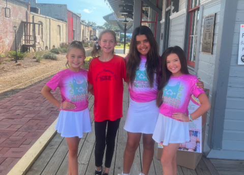 During their fall break from school, students (from left to right ) Haley, Andi Jane, Lila, and Sophie volunteer with Linked Together making mats for the homeless.