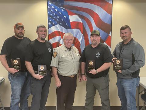 From left to right: Former sheriff’s deputy David Cook, Captain Chris Carroll, Sheriff Mike Cleveland,  Sergeant Chris O’Barr, and Captain Michael Davis.  