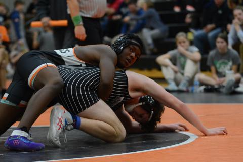 Freshman Champ Blackwell attempts to pin his opponent back on Jan. 16 during their home meet against Dixie. 