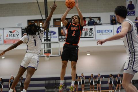 Junior guard O’Brian Evans knocks down a three pointer against the Purple Hurricane defender in the 70-66 road win to pick up Hart County’s first region win of the season. 