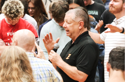 Emmanuel University President  Greg Hearn prays with his students.