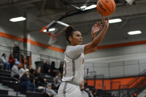Senior forward Alexis Walker drains a three from the Ensley-McCurley Court logo in the 48-40 win over Dawson County. 