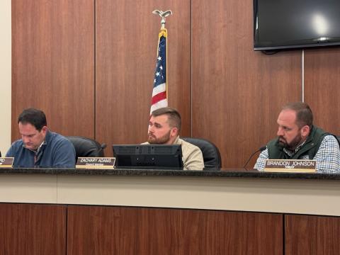 Council members (from left to right) Dan Leard, Zach Adams, and mayor Brandon Johnson hear debate on local alcohol license 