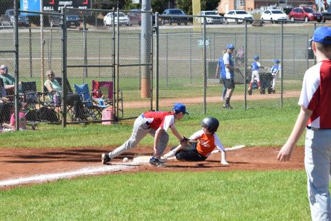 Xavier Robinson (right) slides into third base on Opening Day for Hart County Little League.