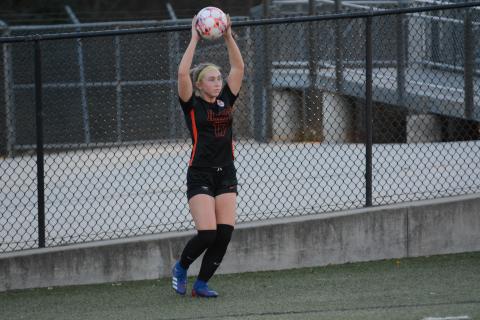 Junior midfielder Teague Pierce looks to throw the ball into play during the 4-1 win against Commerce March 8.