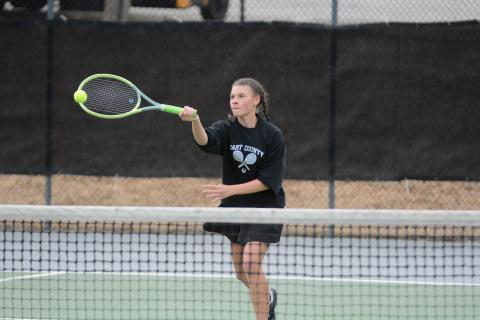 Pictured is Lyla Phillips as she returns a serve as she fell in the 10-point tiebreaker 10-8 against Monroe Area on Feb. 29.