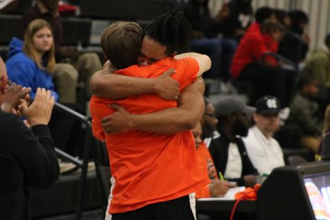 Senior forward Micah Reese hugs Dogs head coach Matt Gibbs as Reese checks out for the final time as a Bulldog. Photo by Grayson Williams/Hart County Charter System