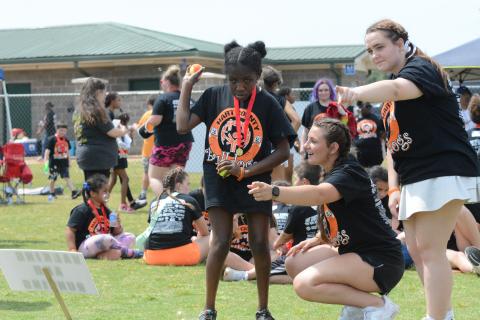 Pictured from left is sophomore Special Olympic athlete Abigal Kent alongside senior Sage Robach and junior Katie Sanders at the ball throw at the Special Olympics April 17.